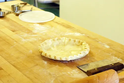 A finished pie crust sits on a chopping block. Taken at King Arthur Flour's Baking Education Center.
