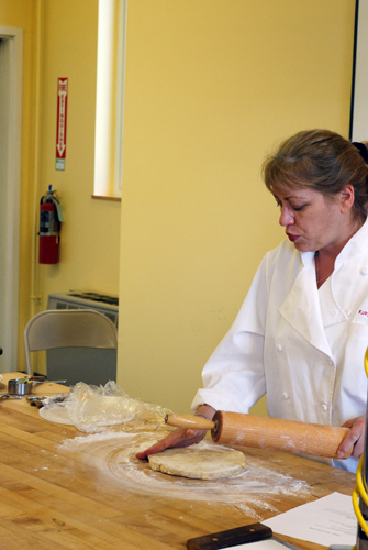 King Arthur Flour baker Robyn rolls out pie crust. Taken at 