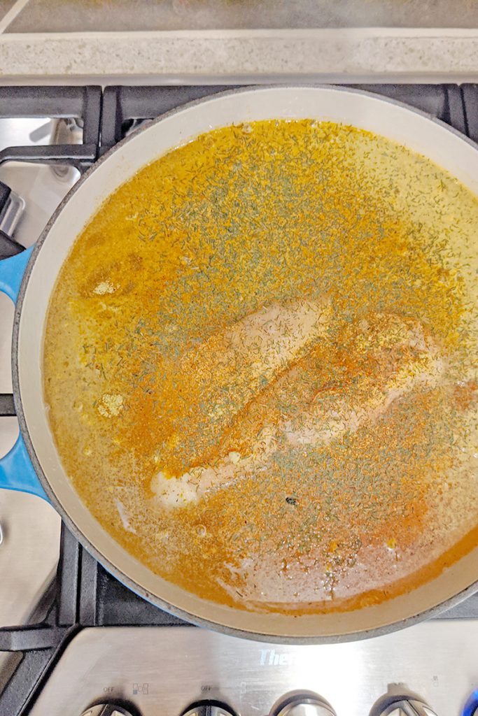 The beginnings of Chicken and Dumplings - frozen chicken, chicken broth, raw baby carrots with spices and dill weed.