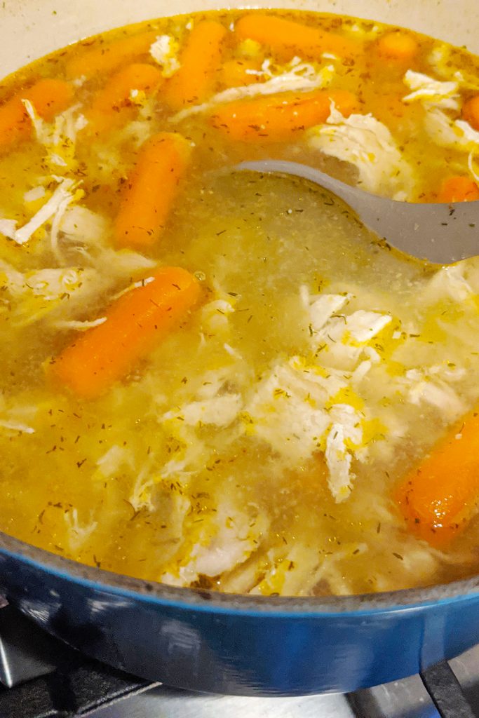Simmered Chicken and Dumplings with carrots, dill, and seasonings. This soup is ready for dumplings to be added. At this point, noodles can be added instead.